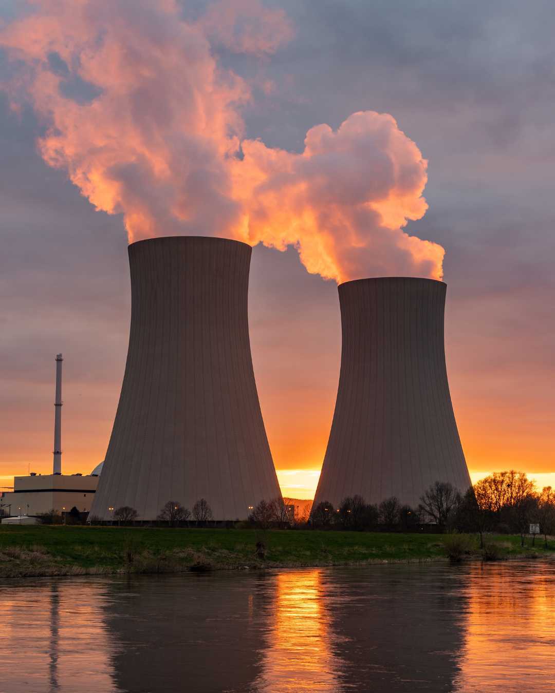 A power plant and cooling towers at sunset